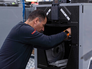 Zehnder reycled production man working on zehnder recycled product