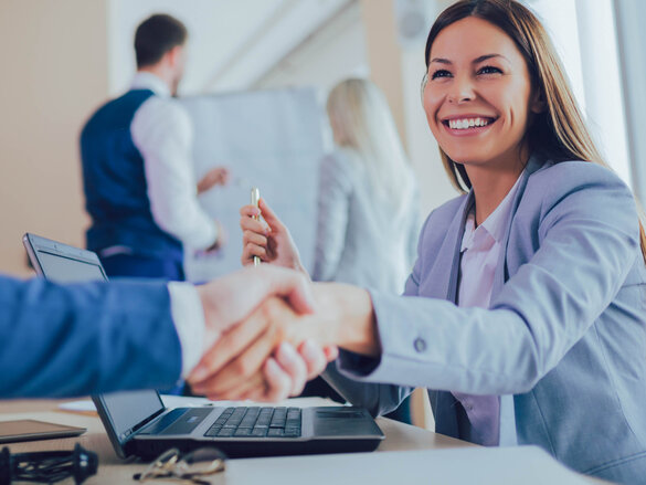 Ethics in everyday life laughing women in business outfit shaking hands