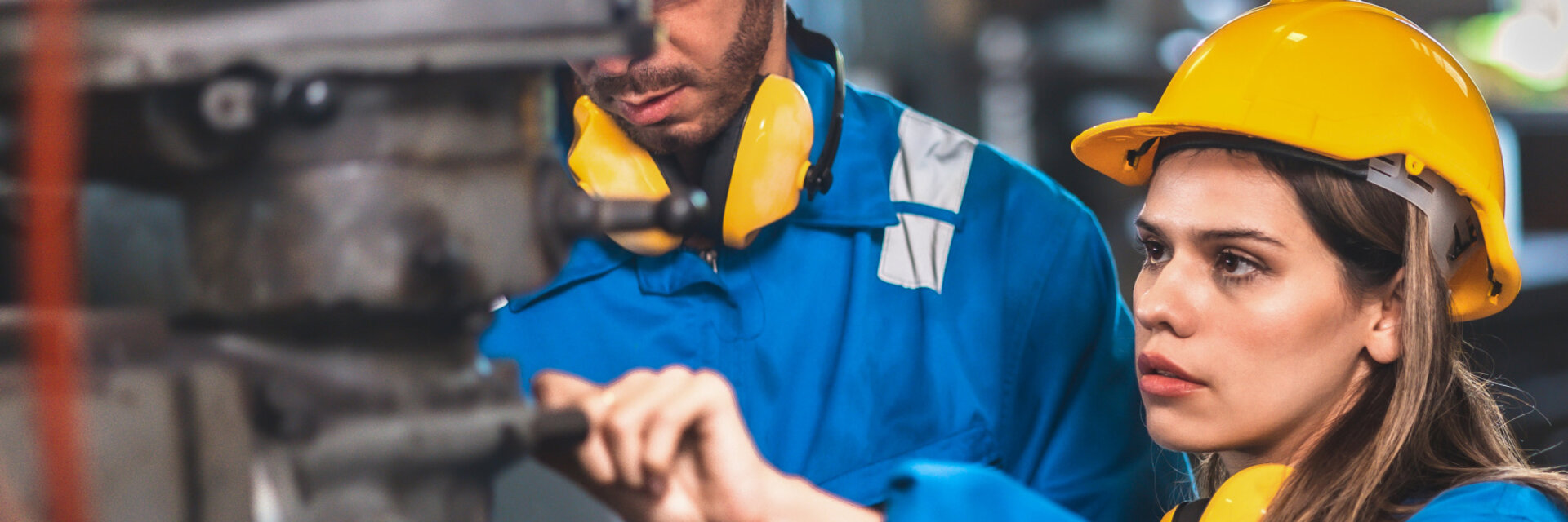 women and men with yellow helmet working at zehnder production